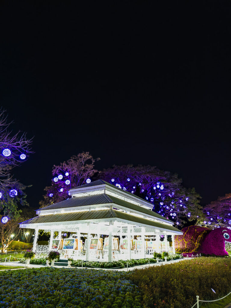 The exterior of the small art gallery and exhibition hall located within the riverside park.