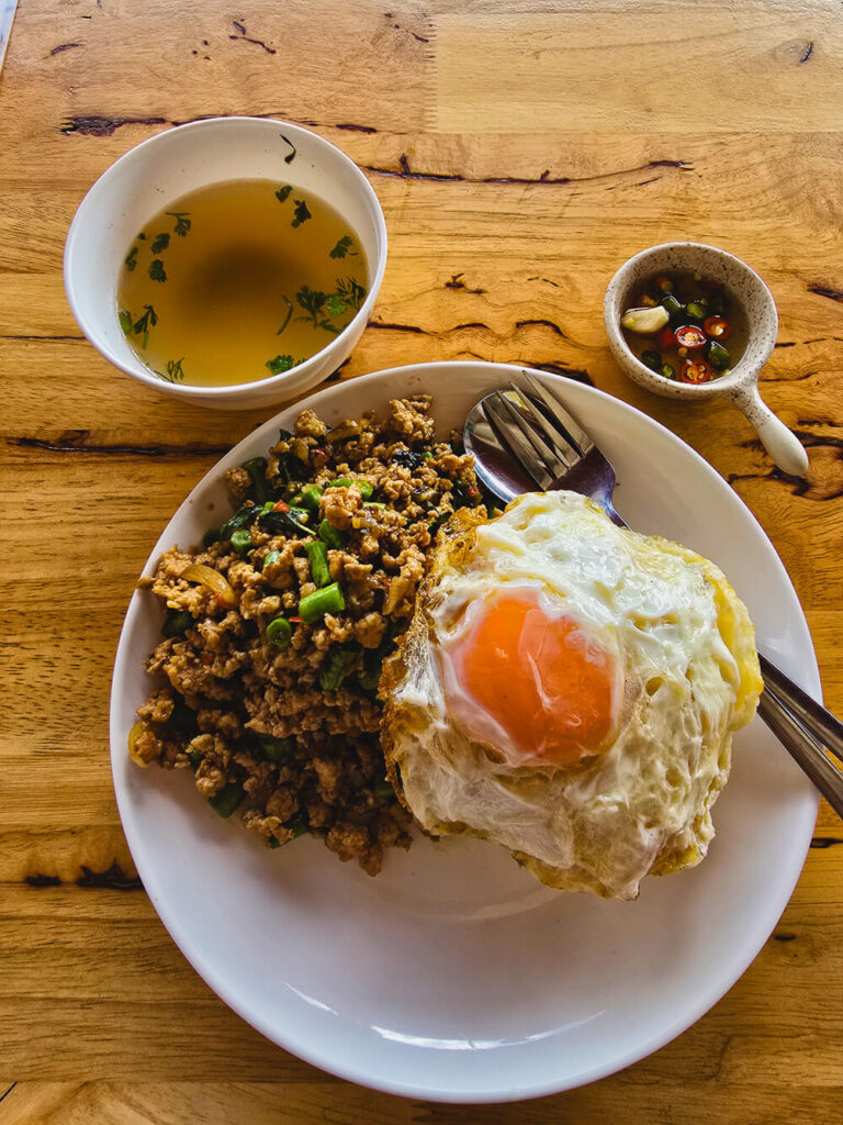Plate of pad kra pao Thai stir-fried basil with rice served at a local Chiang Mai restaurant