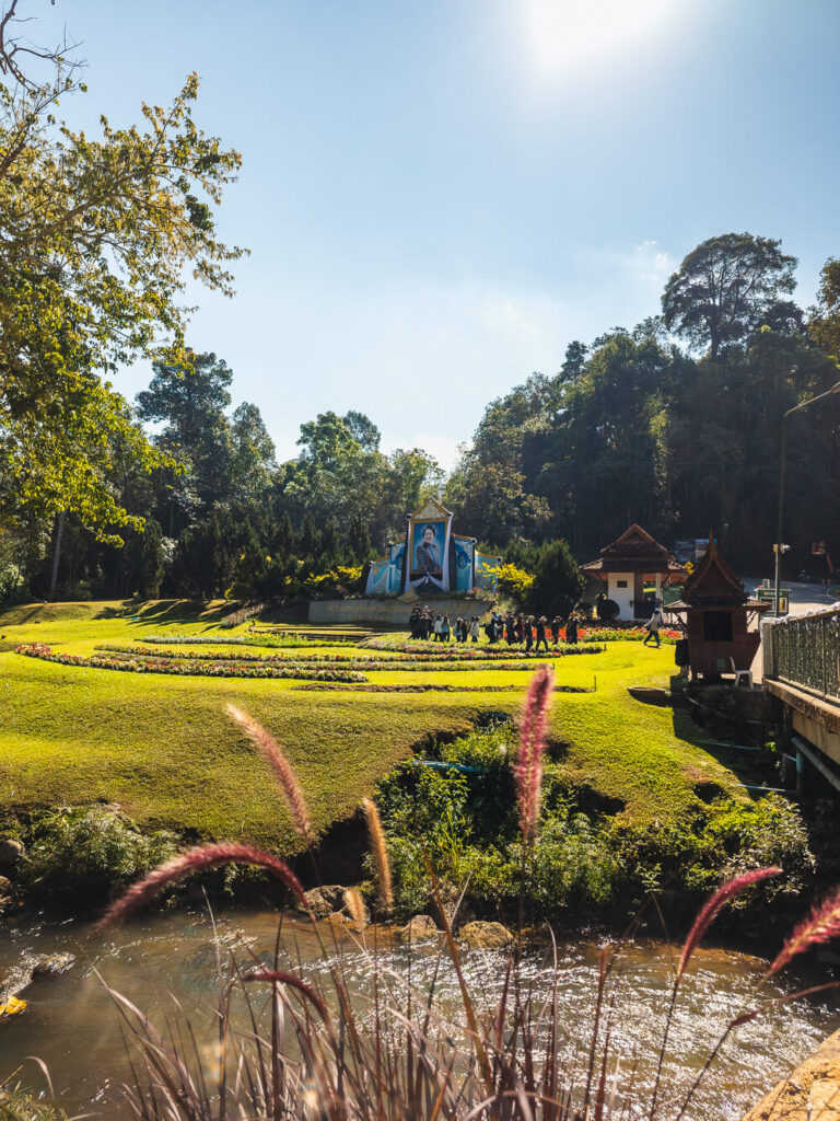 The entrance and landscaped grounds of the Queen Sirikit Botanic Garden, a popular tourist attraction on the Samoeng Loop.