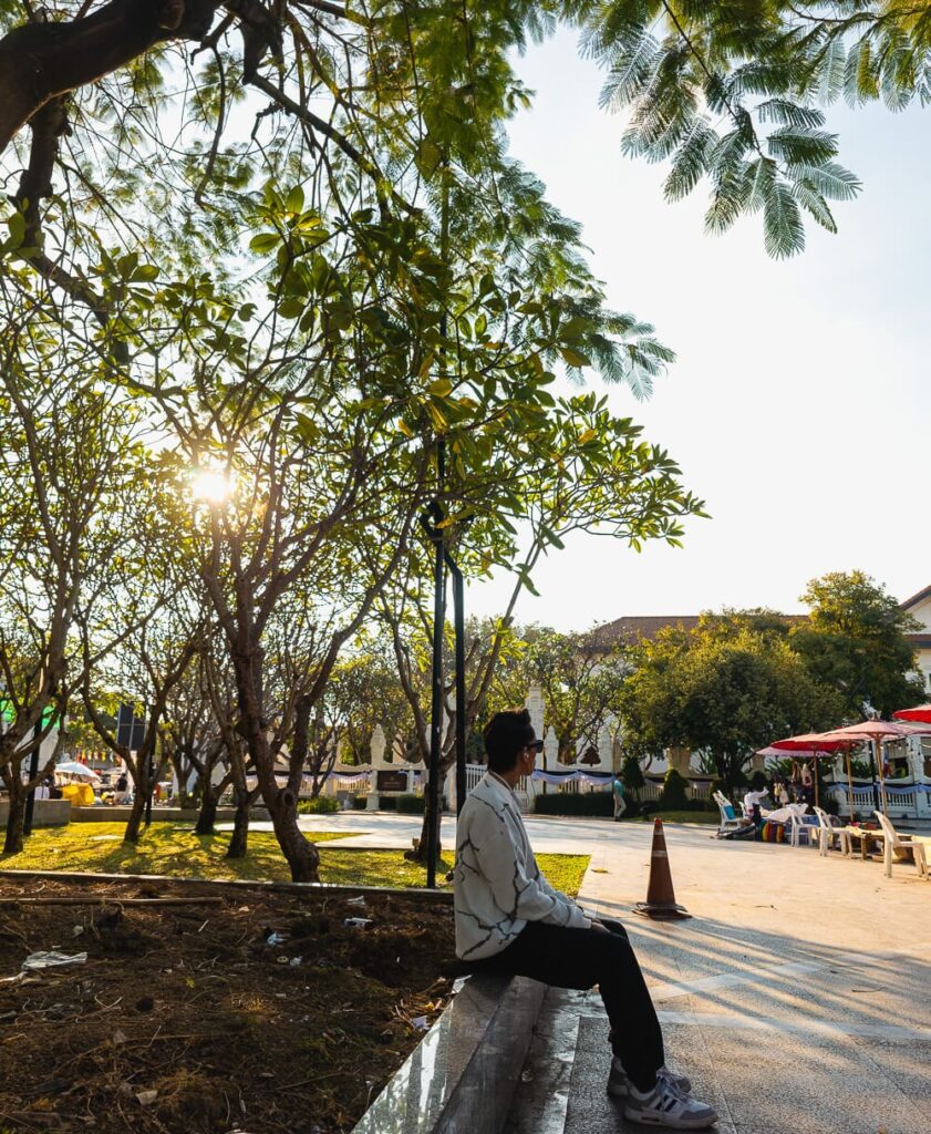 Traveler sitting on a bench near the Three Kings Monument in Chiang Mai