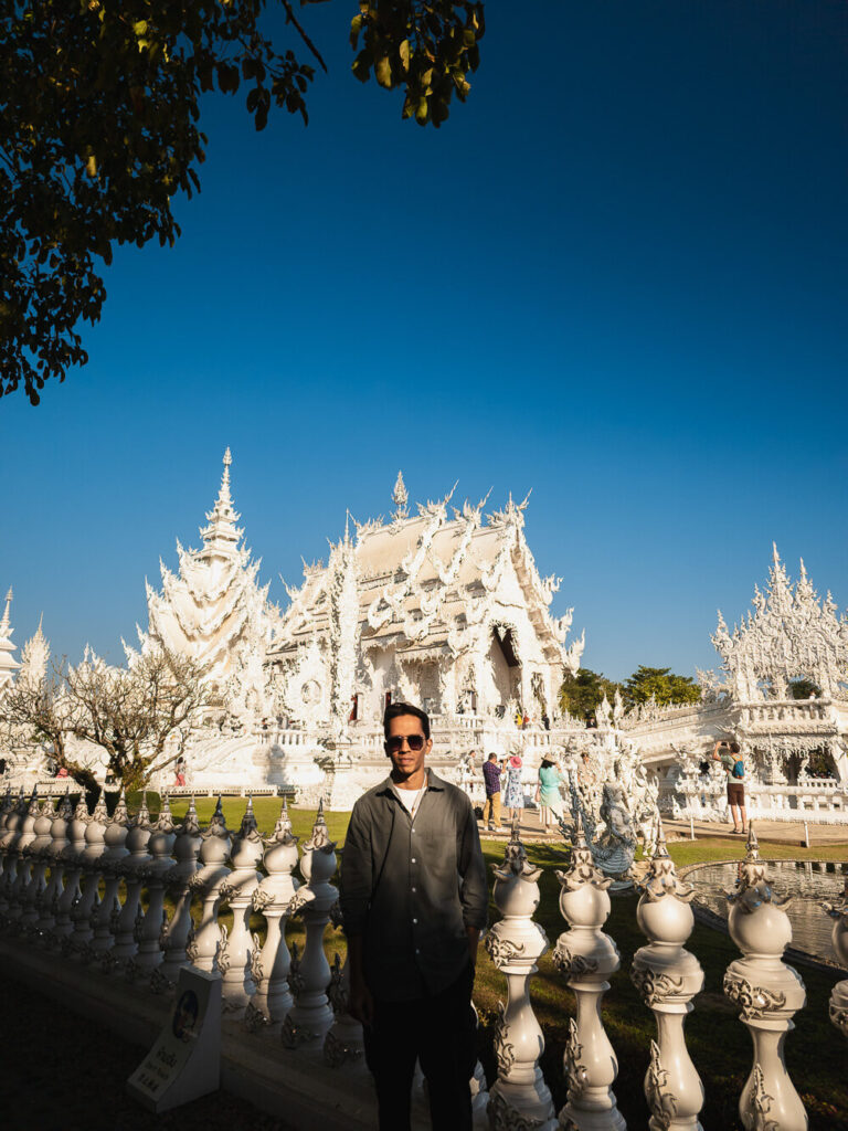 Travel blogger standing in front of White Temple Chiang Rai Wat Rong Khun