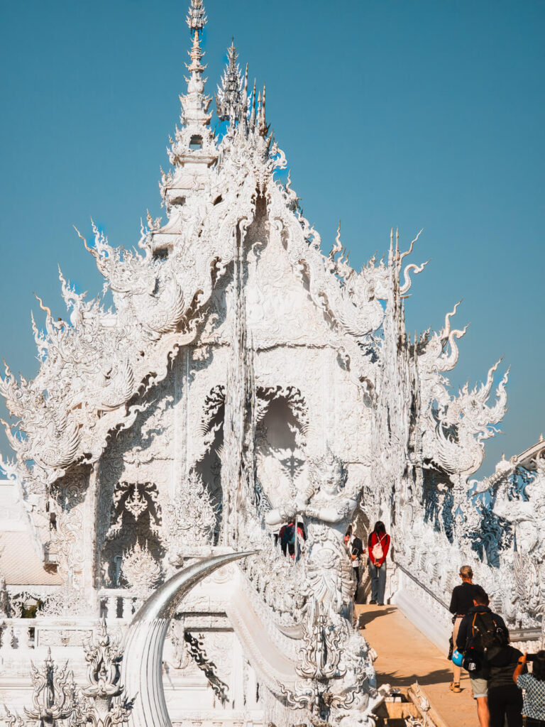 Closeup detail of the intricate white sculptures and mirror fragments at Wat Rong Khun (White Temple) in Chiang Rai.