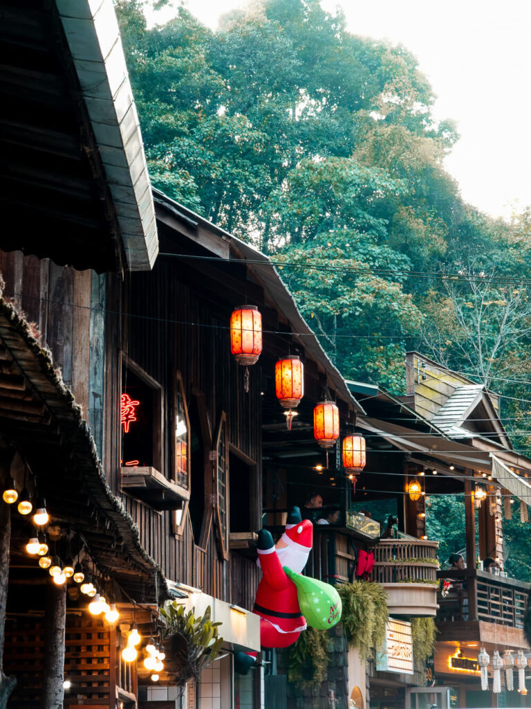 A close up shot of a village restaurant wall featuring a festive Santa Claus balloon decoration.