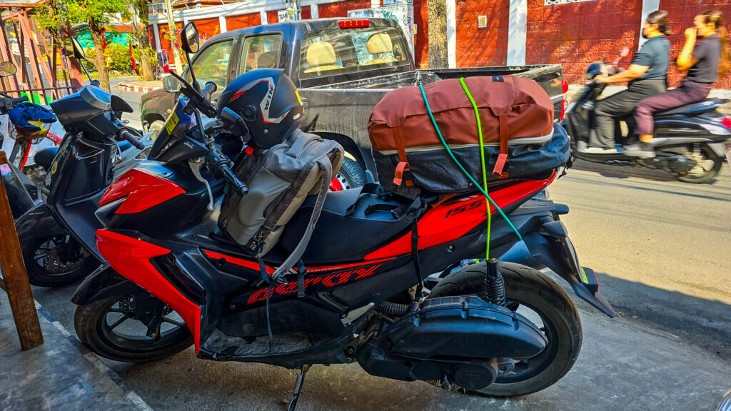 Scooter packed with luggage for a budget trip around Chiang Mai.