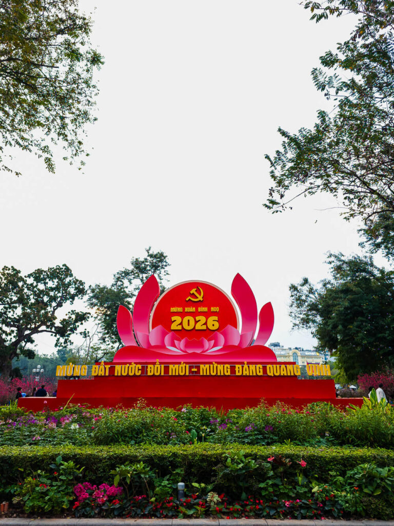 A festive 2026 sign surrounded by bright floral arrangements set up for the Tet Lunar New Year celebrations in Hanoi.