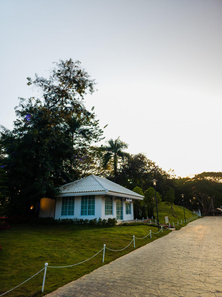 A simple wooden house tucked away in a lush, green mountain valley in the rural north of Thailand.