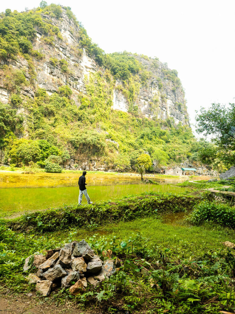 Vishal walking toward the entrance of the secret cave located at Bich Dong Pagoda.