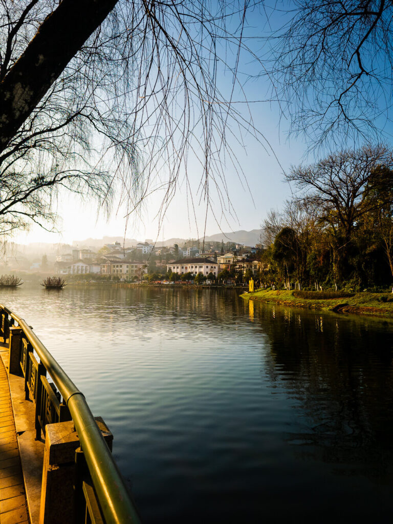 Sapa Lake covered in a light morning fog, showcasing the unpredictable mountain weather.