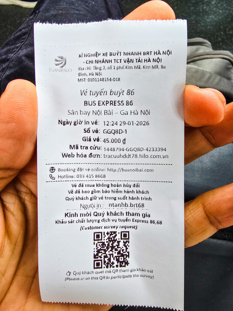 A close-up of a printed paper ticket for Hanoi Bus 86 showing the 45,000 VND fare.