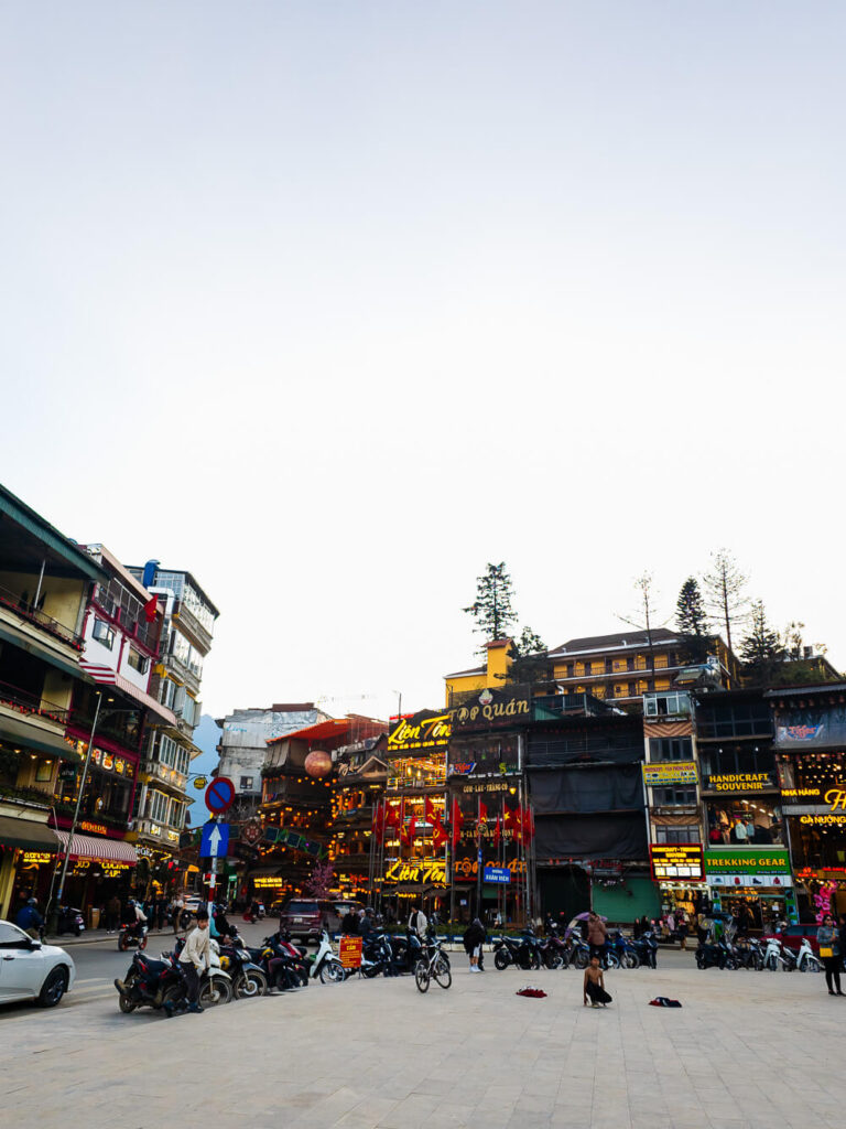 A wide panoramic shot showcasing the colorful, French-inspired European architecture of the buildings in Sapa town.