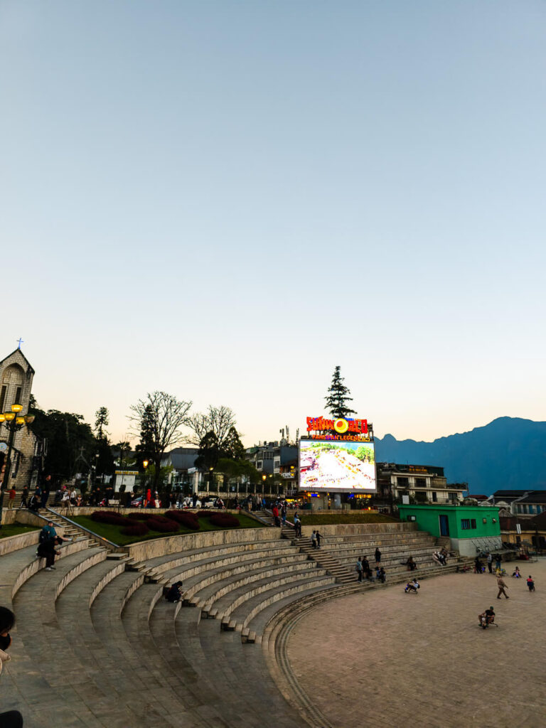 The main Sapa Town Square featuring stadium-style seating and a large screen for local events and gatherings.