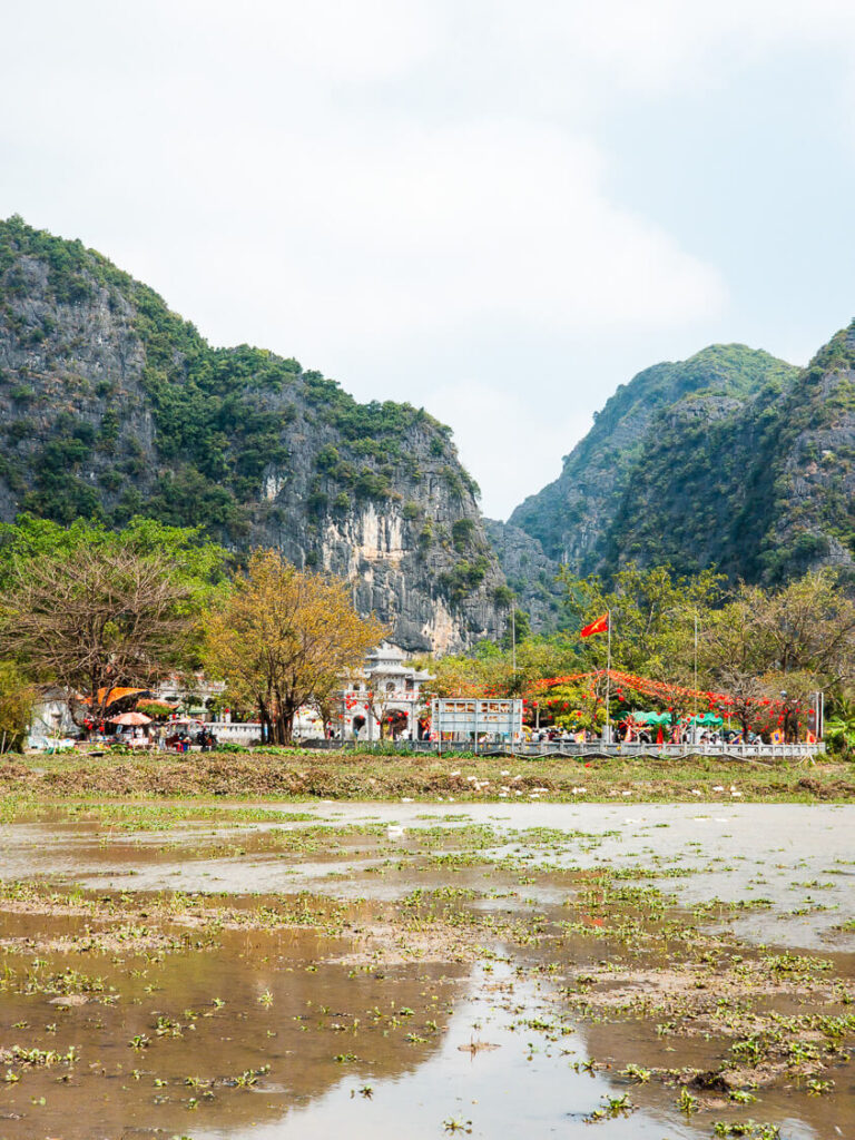 The stone architecture of Thai Vi Temple in Ninh Binh during the afternoon sun.