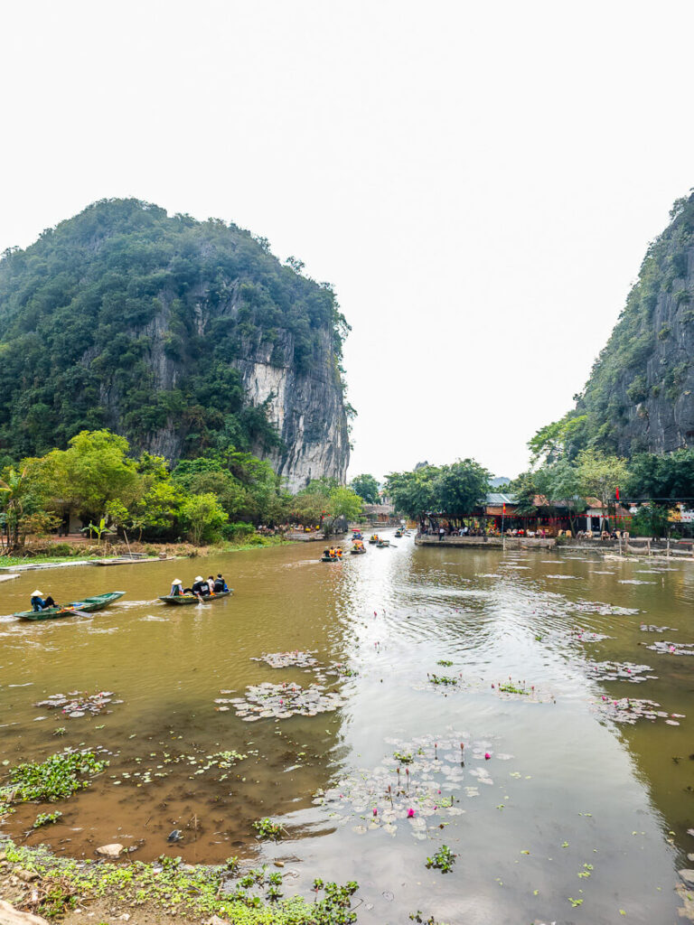 Rows of wooden rowing boats docked on the river in Tam Coc Ninh Binh.