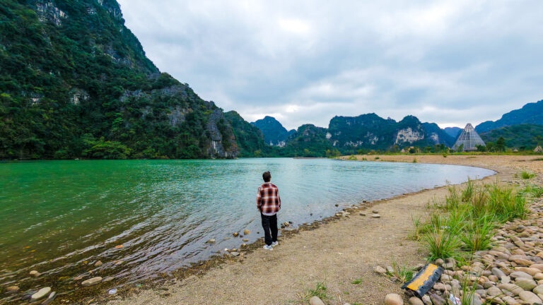 Me standing by a lake at Trang An while researching this Ninh Binh Budget Travel Guide 2026.