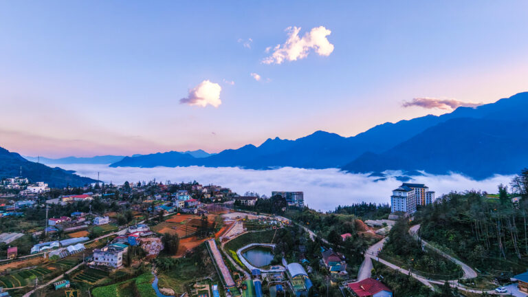 A wide drone shot of the mountains and city clouds for anyone riding a scooter in sapa vietnam for first timers
