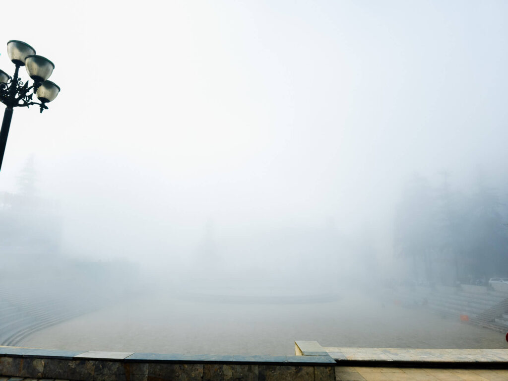 The stone steps of the sapa amphitheater disappearing into a solid wall of white mist