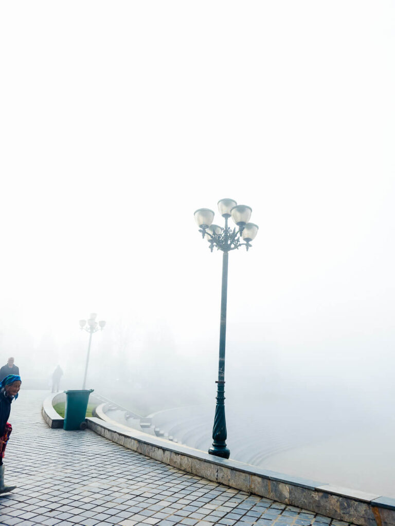 A side view of the amphitheater seating area being overtaken by thick mountain fog