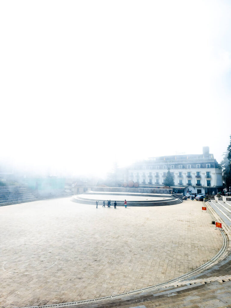 A wide shot showing fog covering half of the sapa amphitheater while the other side is clear