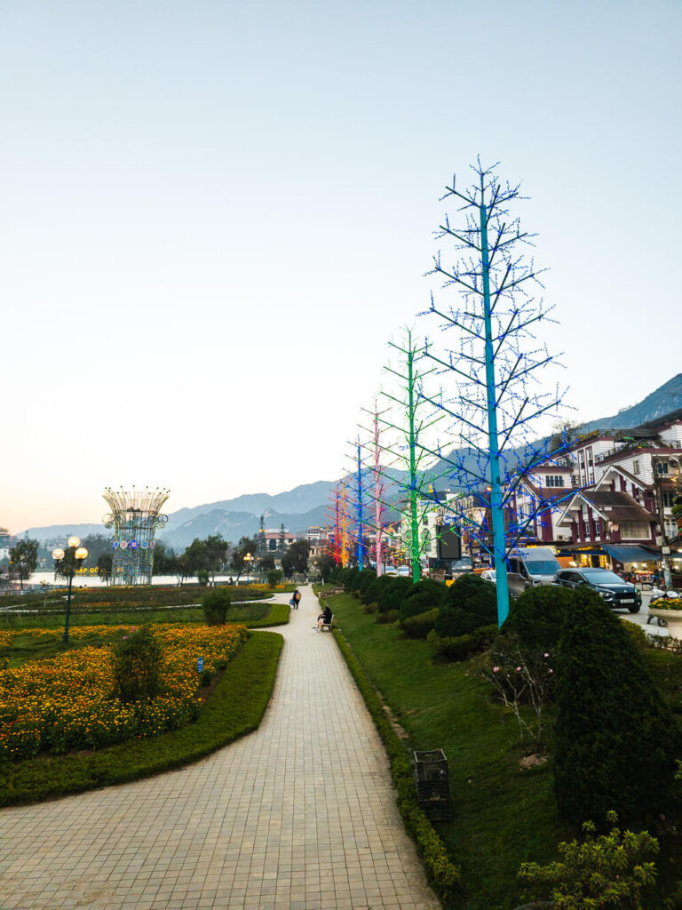 Colorful flower beds and walking paths in the park near sapa lake during twilight