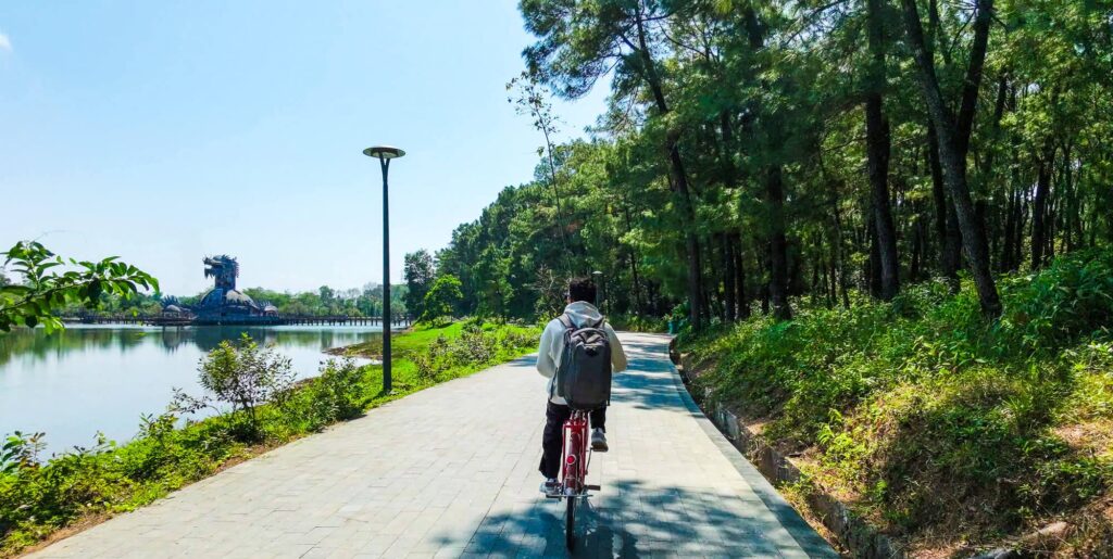 Riding a bicycle along the quiet overgrown pathways of the abandoned water park