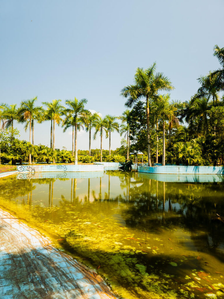 Empty abandoned swimming pool filled with leaves and debris at the former recreation park