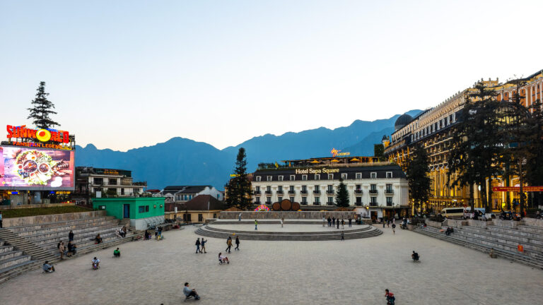 The stone amphitheater in the center of Sapa town with mist-covered mountains in the background, the final reward after getting from Hanoi to Sapa.