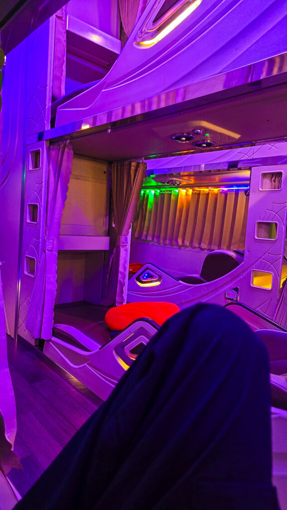 The interior cabin view of a standard Vietnamese sleeper bus showing three rows of double-decker bunk berths.