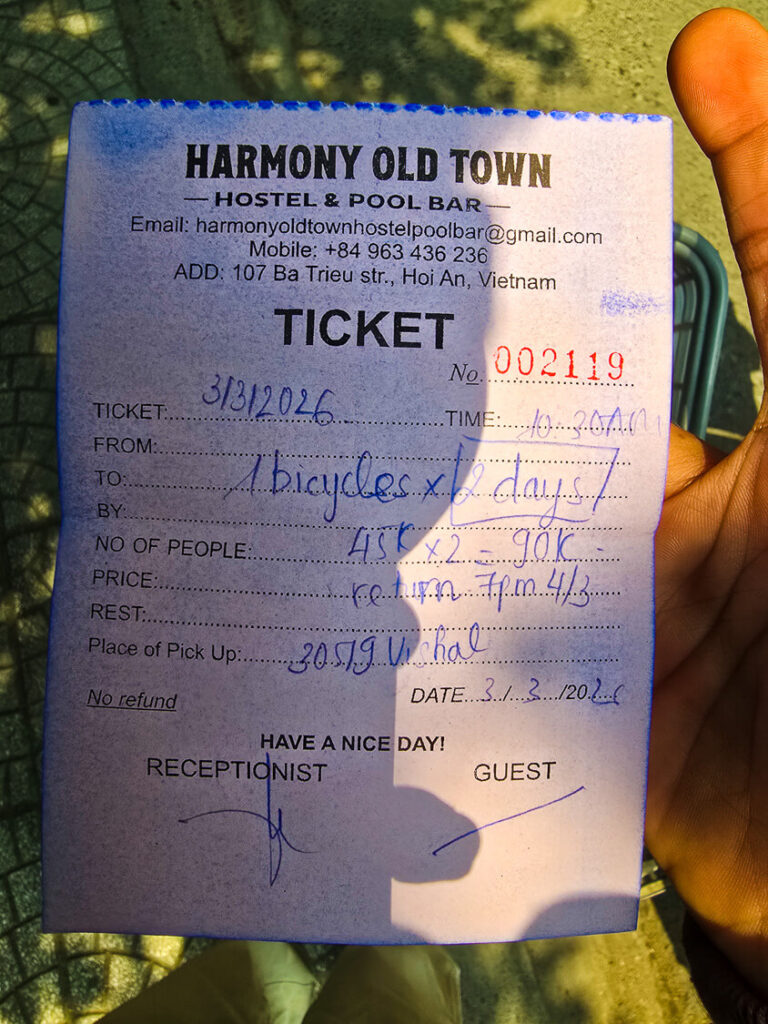 A small paper receipt displaying the exceptionally low price for a full day bicycle rental in Vietnam.