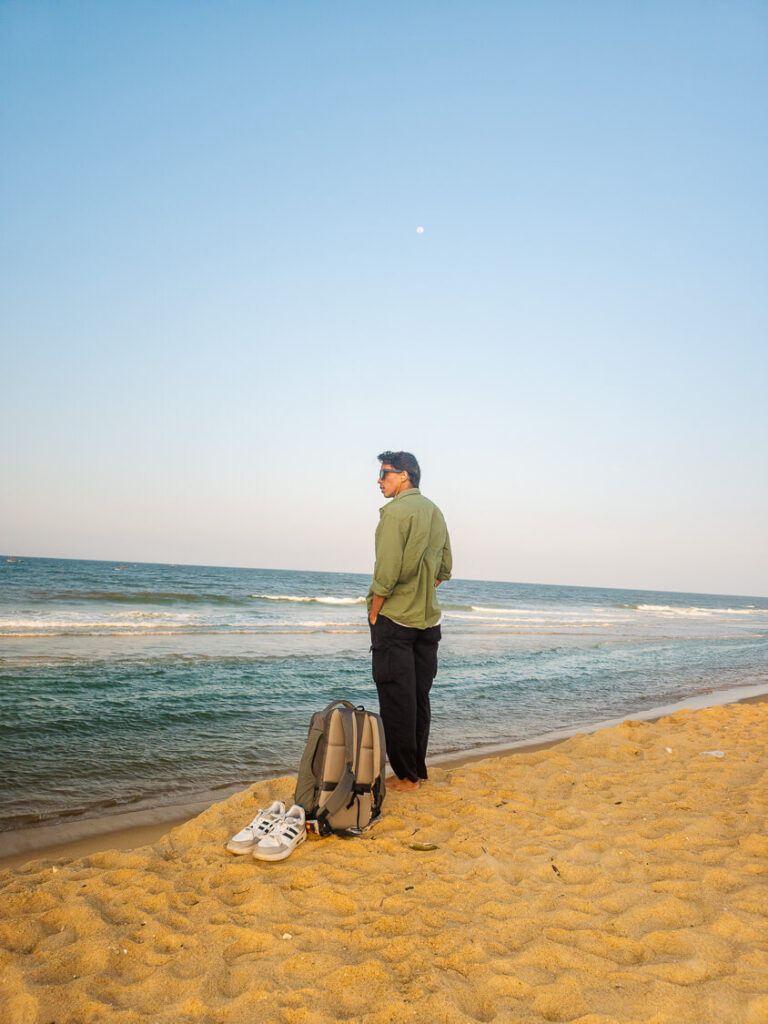 Vishal standing on the wide, quiet, and uncrowded shores of Thuan An Beach, located just outside of Hue.