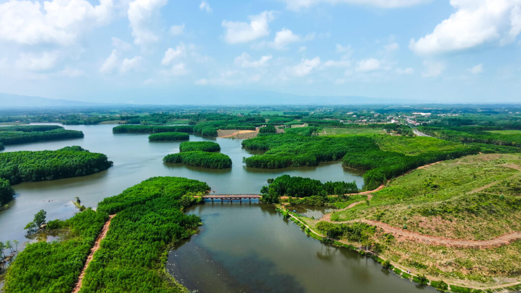 Aerial drone view of the lush mountains and jungle surrounding the My Son Sanctuary.