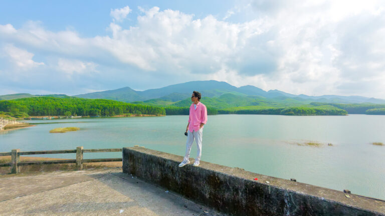 A slow traveler standing on the quiet dam of Khe Tan reservoir, a hidden gem featured in this Hoi An travel guide for slow travelers.