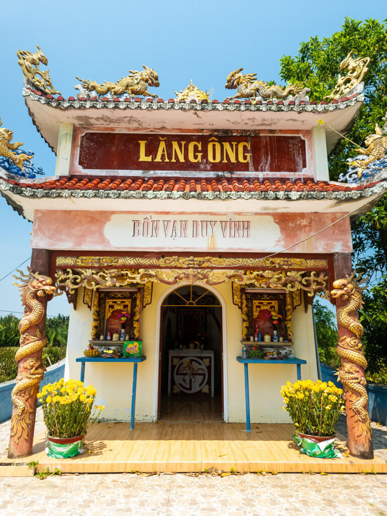 Close-up architectural detail of the wooden main door at the Bon Van Duy Vinh boat temple.