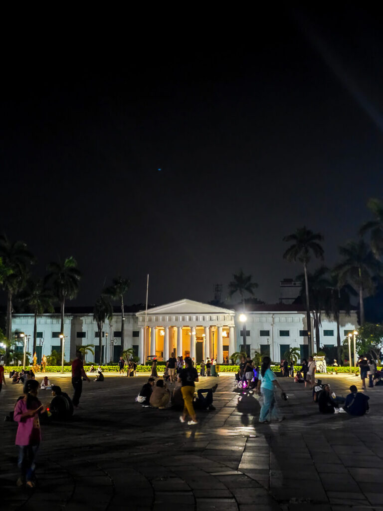 How to Travel from Yogyakarta to Jakarta: Transport Guide 2026 2 Colonial Dutch architecture and crowds gathering in the bustling Kota Tua square surrounding the Jakarta History Museum.