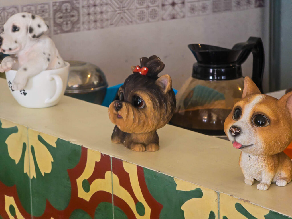 Yogyakarta Travel Budget: How Much Does Yogyakarta Cost? 2 Cute small dog figurines decorating a budget friendly hostel in Yogyakarta
