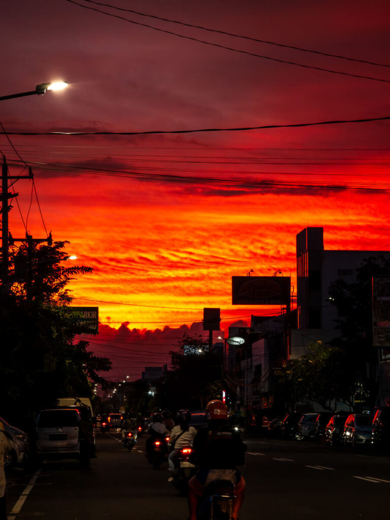 Where to Stay in Yogyakarta: Best Areas for Every Traveler 6 A warm, golden sunset glowing over the streets and skyline of Yogyakarta, Indonesia.